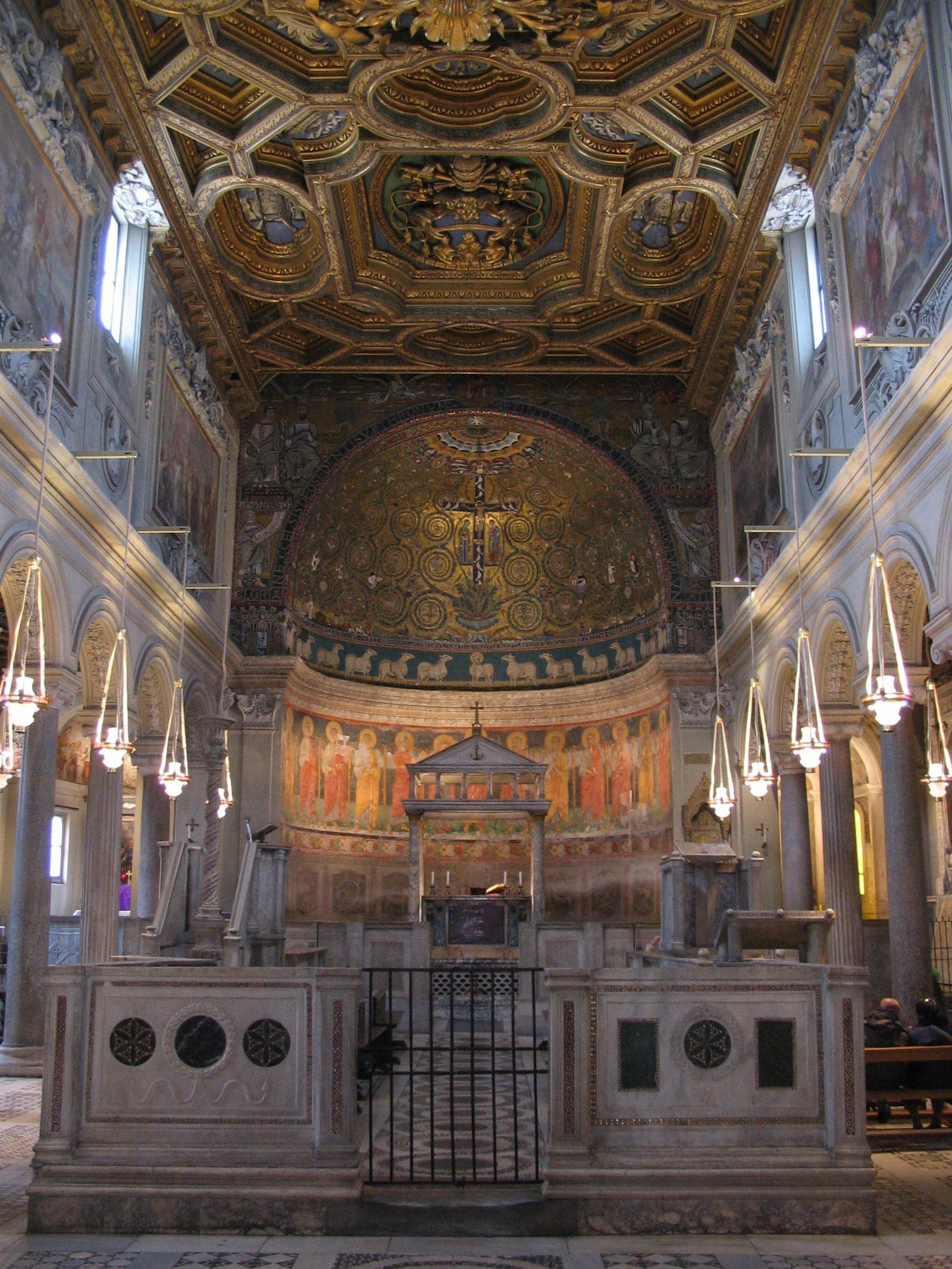 Interior of San Clemente in Rome with nave and apse mosaic.